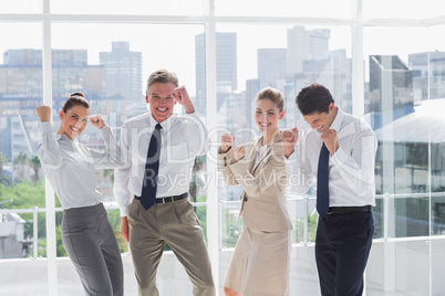 Group of business people raising arms as a success