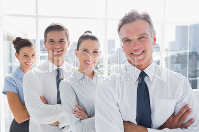 Smiling business people standing together in line