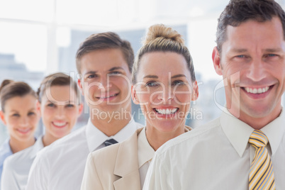 Smiling handsome businessman standing with his team