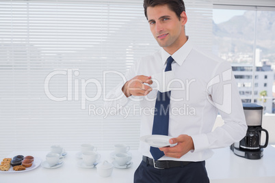 Smiling businessman having a coffee during the break