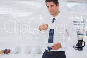 Smiling businessman having a coffee during the break