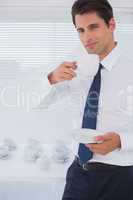 Handsome businessman having a coffee