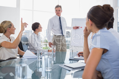 Businesswoman asking something during a meeting