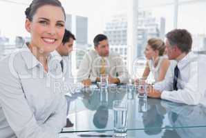 Smiling brunette businesswoman in a meeting