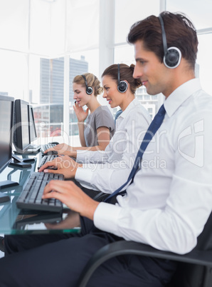 Group of call center employees working in line