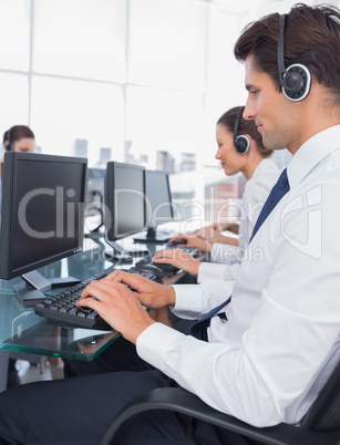 Group of call center employees working on computers