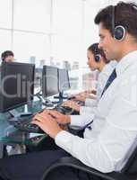 Group of call center employees working on computers