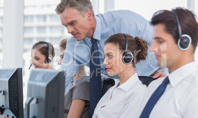 Manager helping call centre agent