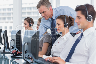 Smiling manager helping call centre agent