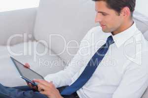 Attractive businessman using digital tablet