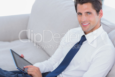 Smiling businessman using digital tablet