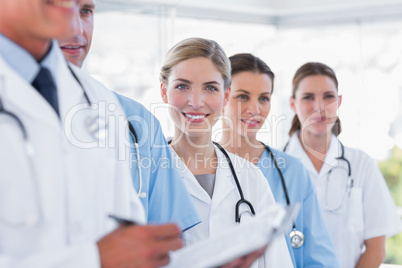 Smiling medical team in row