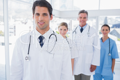 Attractive doctor in front of his team