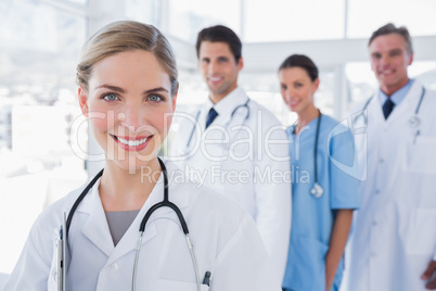 Woman doctor in front of her colleagues