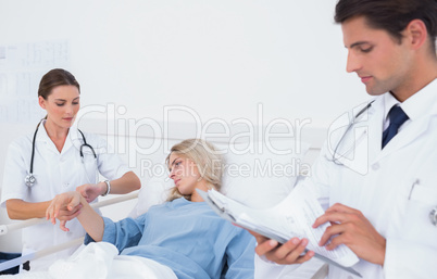 Doctor taking pulse of a patient