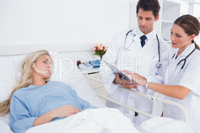 Hospitalized woman and doctors