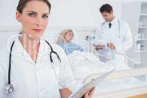 Serious doctor holding folder