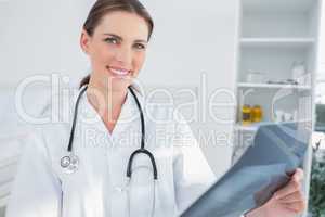 Smiling woman doctor holing a radiography