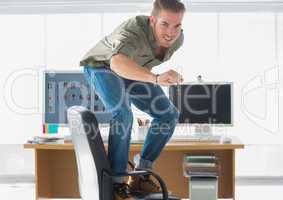 Smiling man surfing his office chair