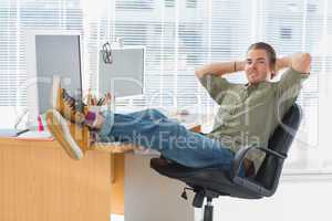 Designer relaxing with foot on the desk