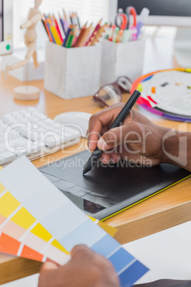 Interior designer with graphics tablet and colour chart