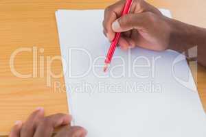 Man drawing with a red pencil