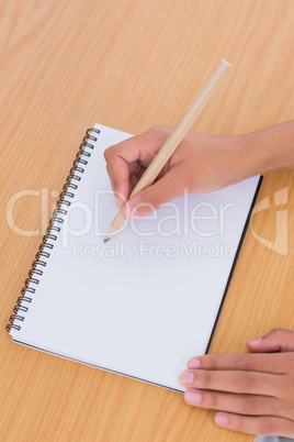 Woman drawing on a paper on a desk