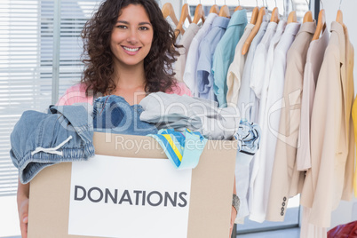 Volunteer holding clothes donation box