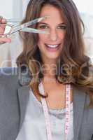 Creative designer holding scissors