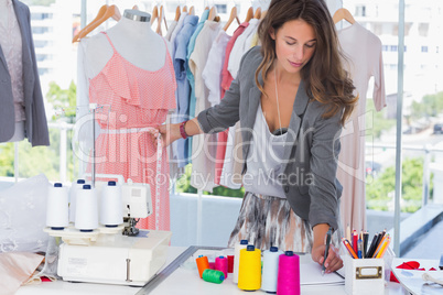 Fashion designer measuring a mannequin