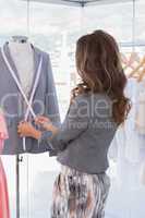 Fashion designer measuring blazer lapel