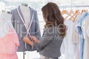 Fashion designer measuring blazer