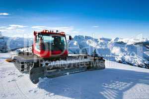 snow-grooming machine on snow hill