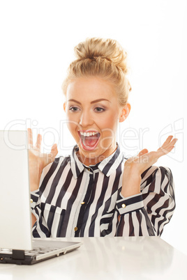 exited blonde woman working on laptop