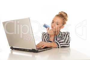 woman using credit card working on her laptop