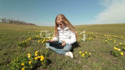 Child Using a Touch Screen Tablet PC Outdoors