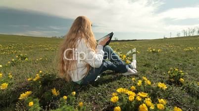 Child Using a Touch Screen Tablet PC Outdoors