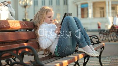 Urban Scene - Child Using Touch Screen Tablet PC