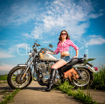 Biker girl sitting on motorcycle