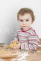 young child making cookies