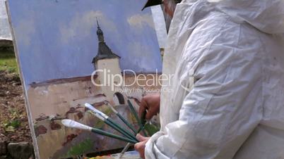 Artist paints a picture of Kirillo-Belozersky Monastery in Russia.