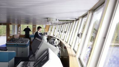 Navigation officer driving the cruise liner on the river 1