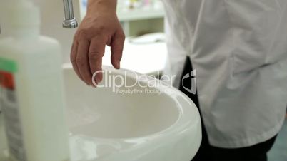 doctor washes his hands with soap in the office