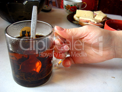 hand with a cup of tea