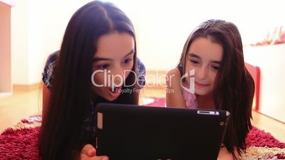 Happy teenage girls having fun using tablet pc