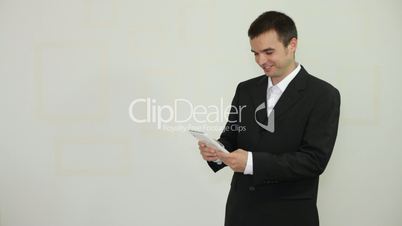 Happy businessman with tablet