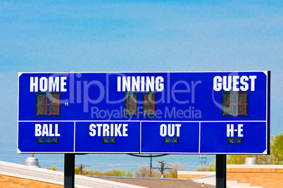 Baseball scoreboard with blue sky