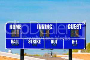 Baseball scoreboard with blue sky