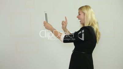 Happy businesswoman photographing with tablet