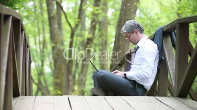 A young self-confident businessman using laptop